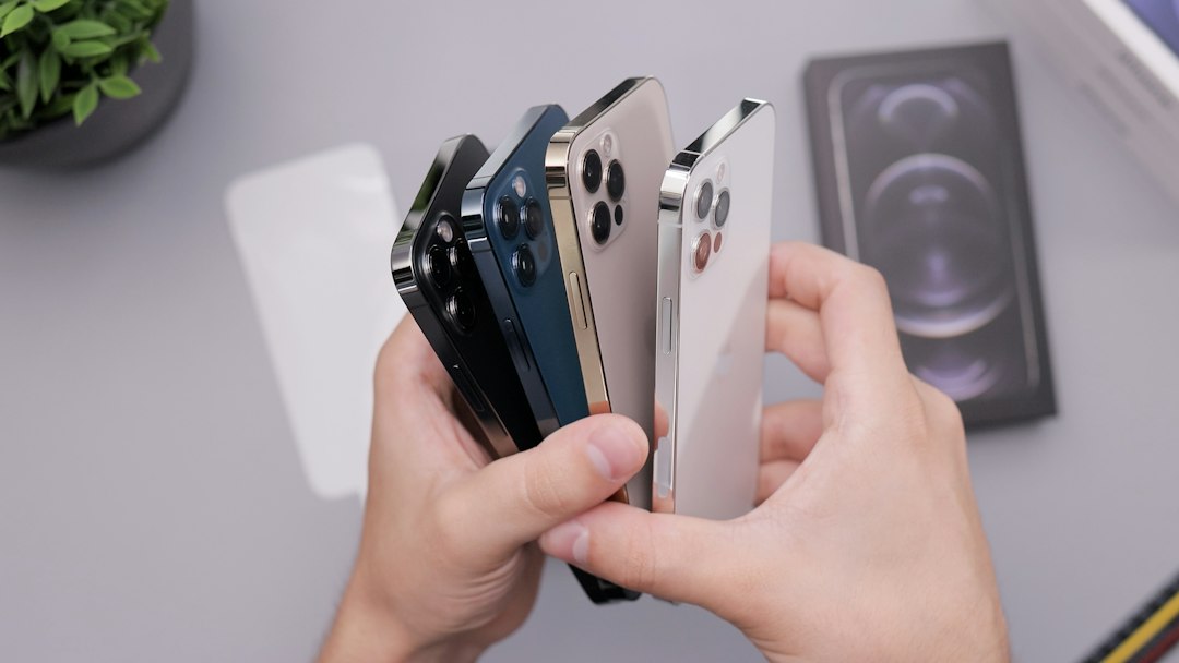 person holding white and black iphone case