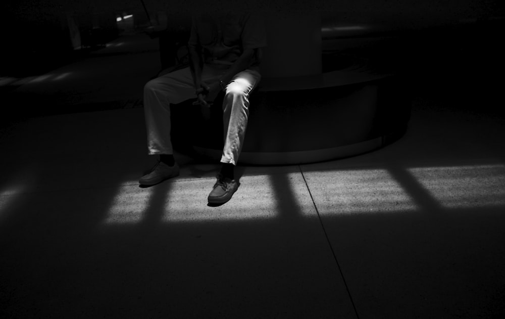 man in black suit sitting on chair