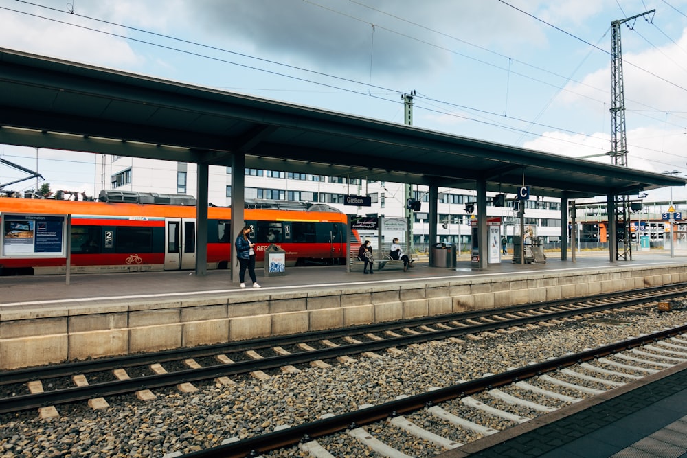 red and white train on rail during daytime