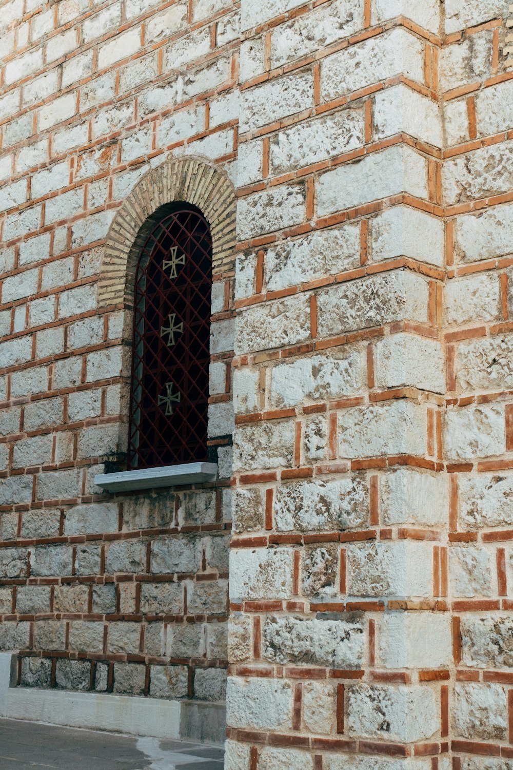 black wooden window on brown brick wall