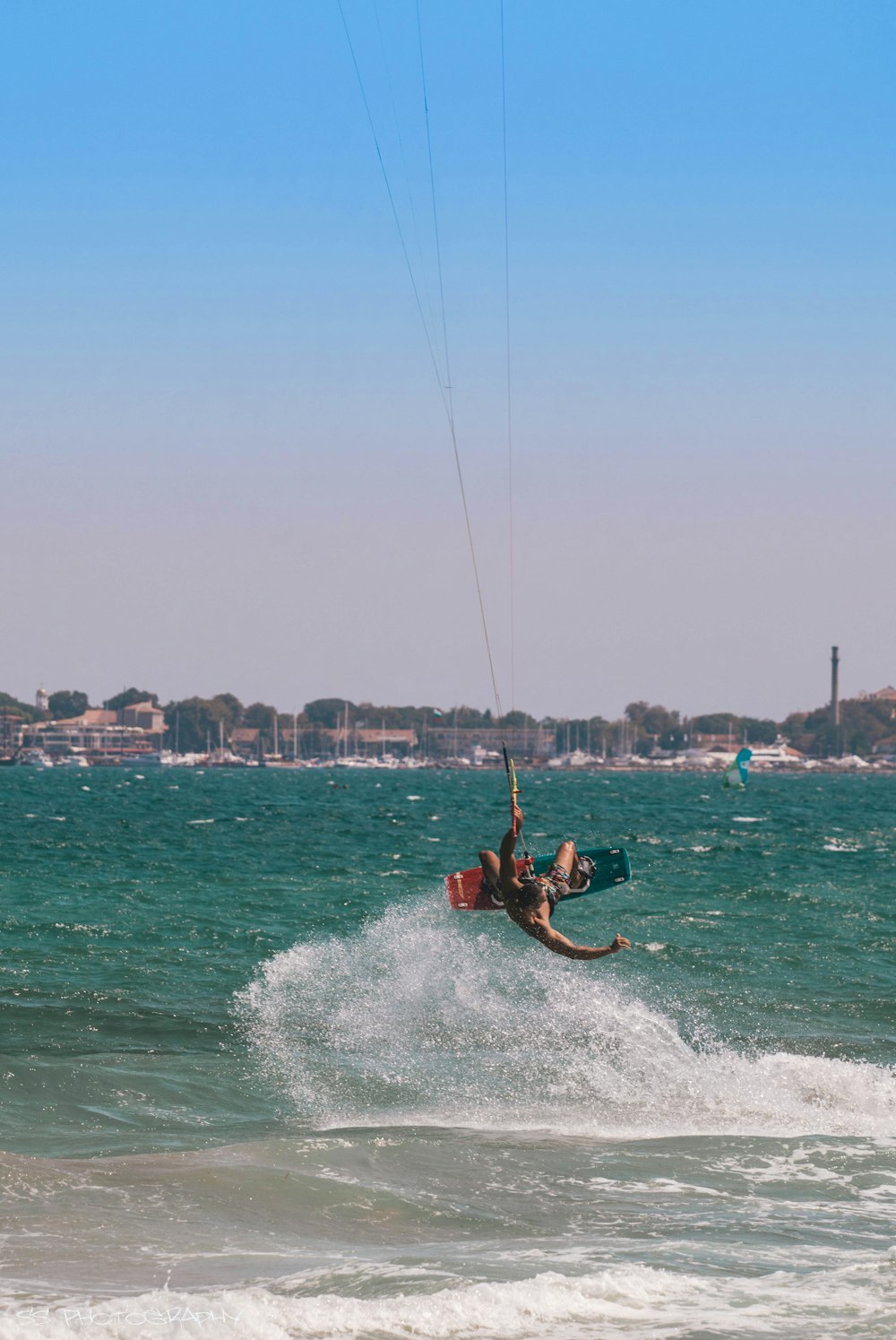 man in red shorts surfing on sea during daytime