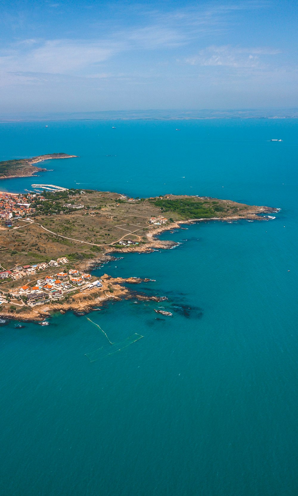 aerial view of city near body of water during daytime