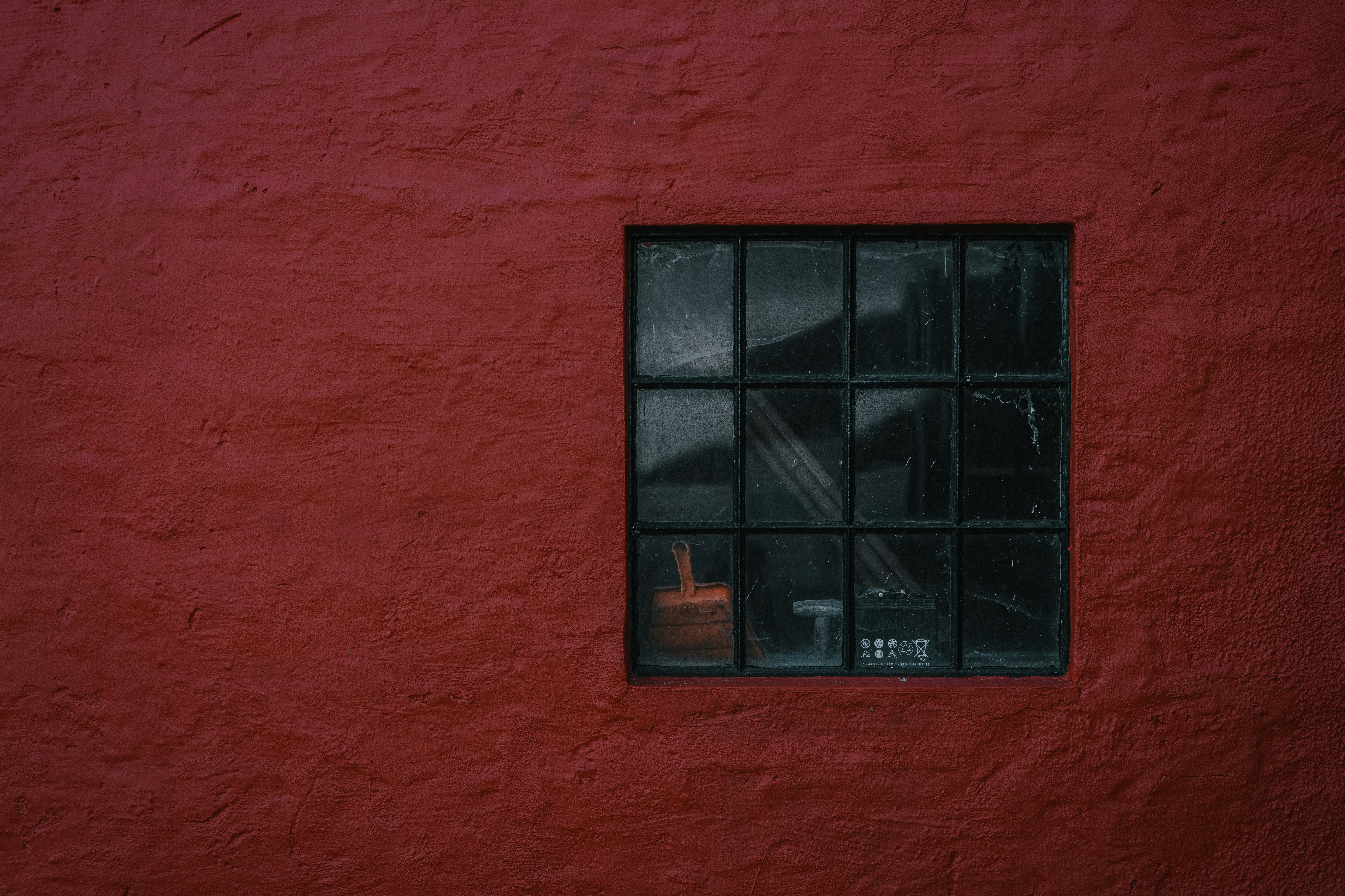 black-wooden-window-frame-on-red-wall