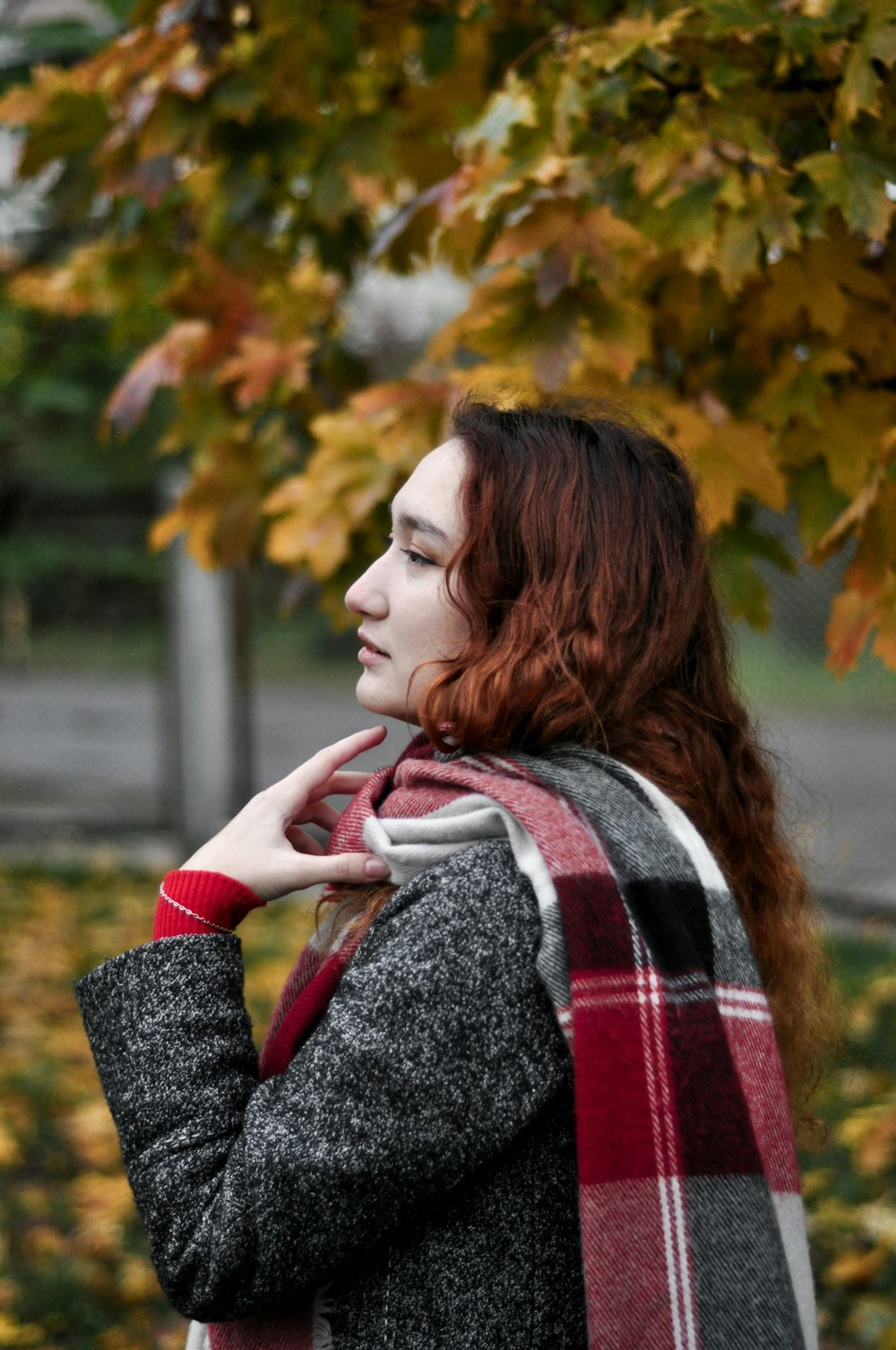 woman in red and white scarf and gray sweater