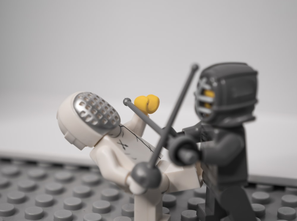 lego minifig holding black camera