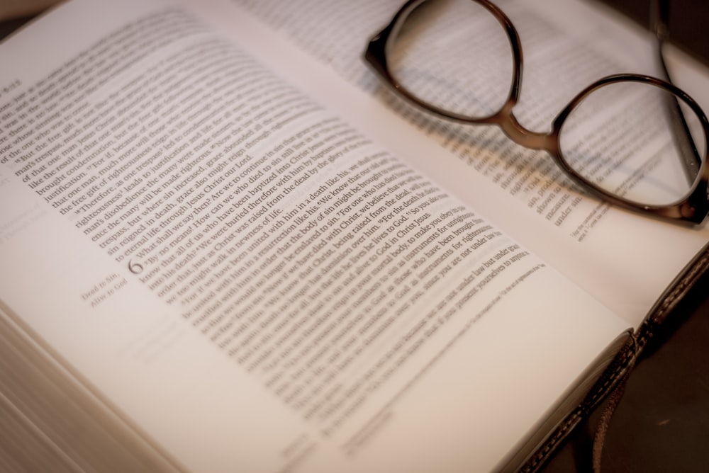 black framed eyeglasses on white book page