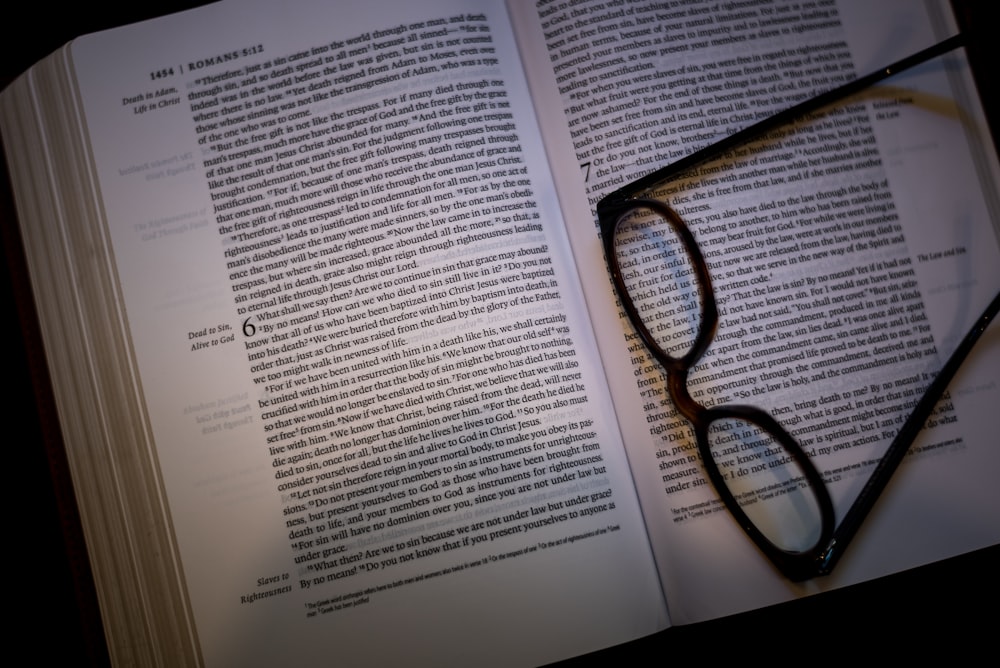 black framed eyeglasses on white book page