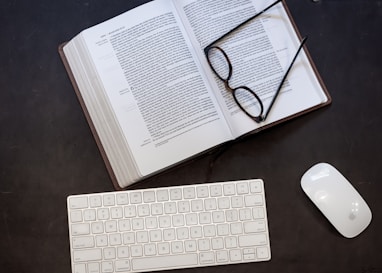 black framed eyeglasses on white printer paper