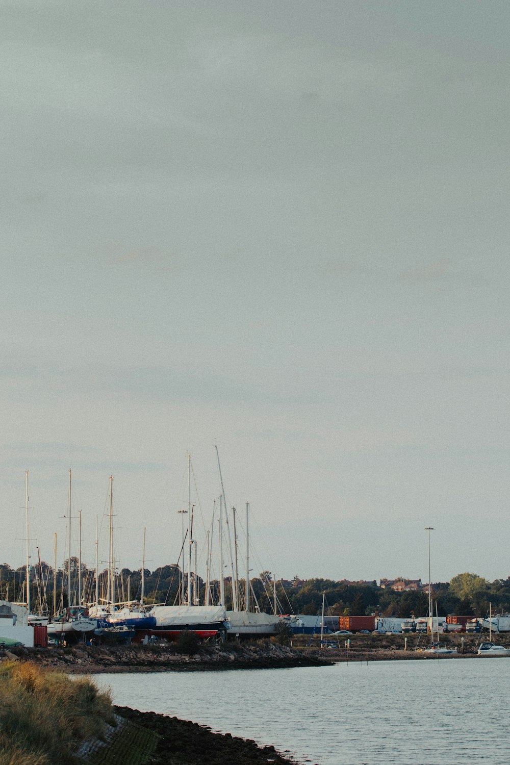 white and blue boat on sea under gray sky