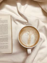 white ceramic mug on white textile