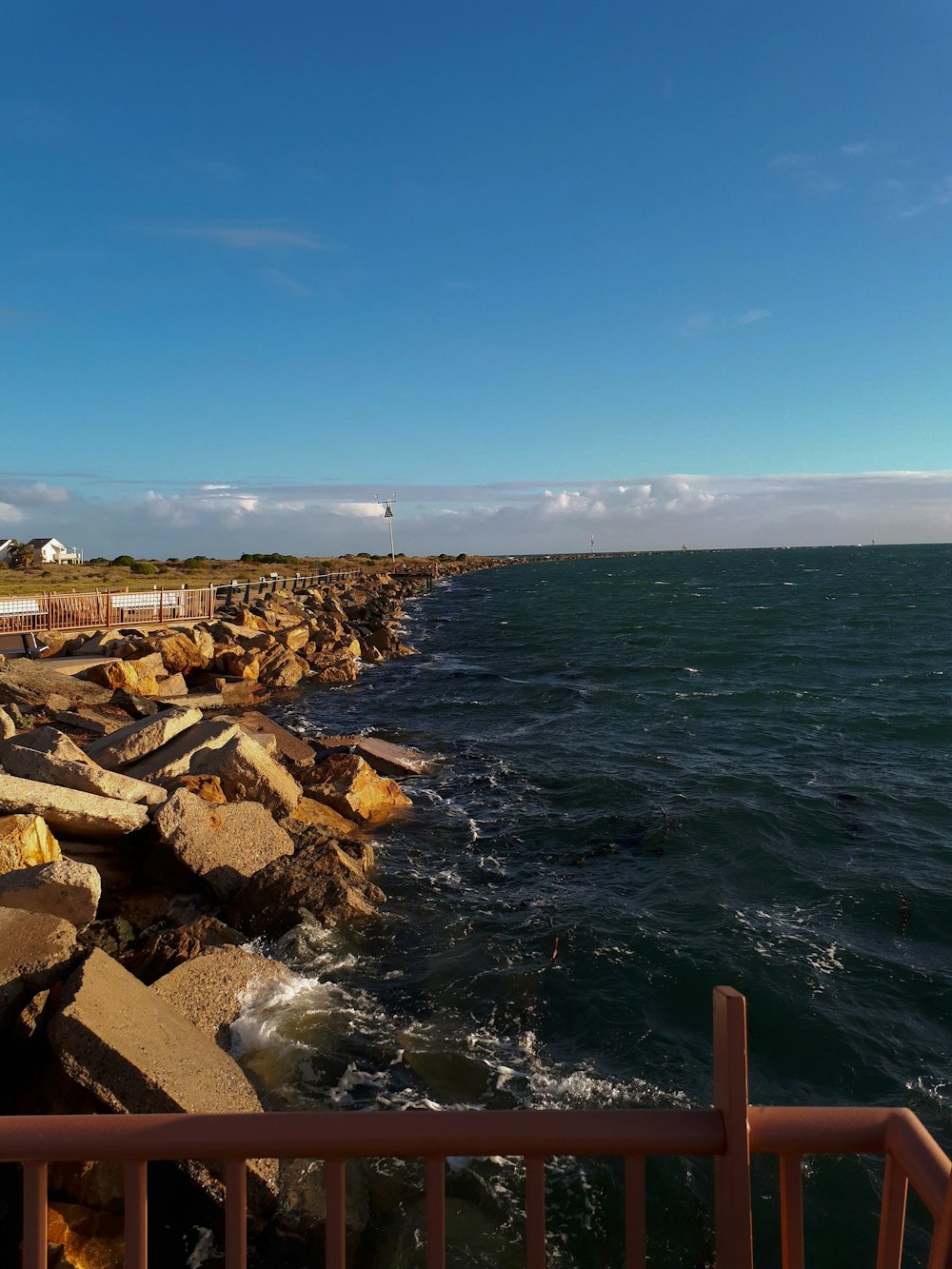 brown rocks near body of water during daytime