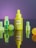 A neon yellow dropper bottle labeled 'not pot CBD Glow Oil' is centrally positioned, surrounded by geometrically shaped translucent objects including cubes and spheres. The background has a gradient of purple, adding a vibrant contrast to the foreground elements.