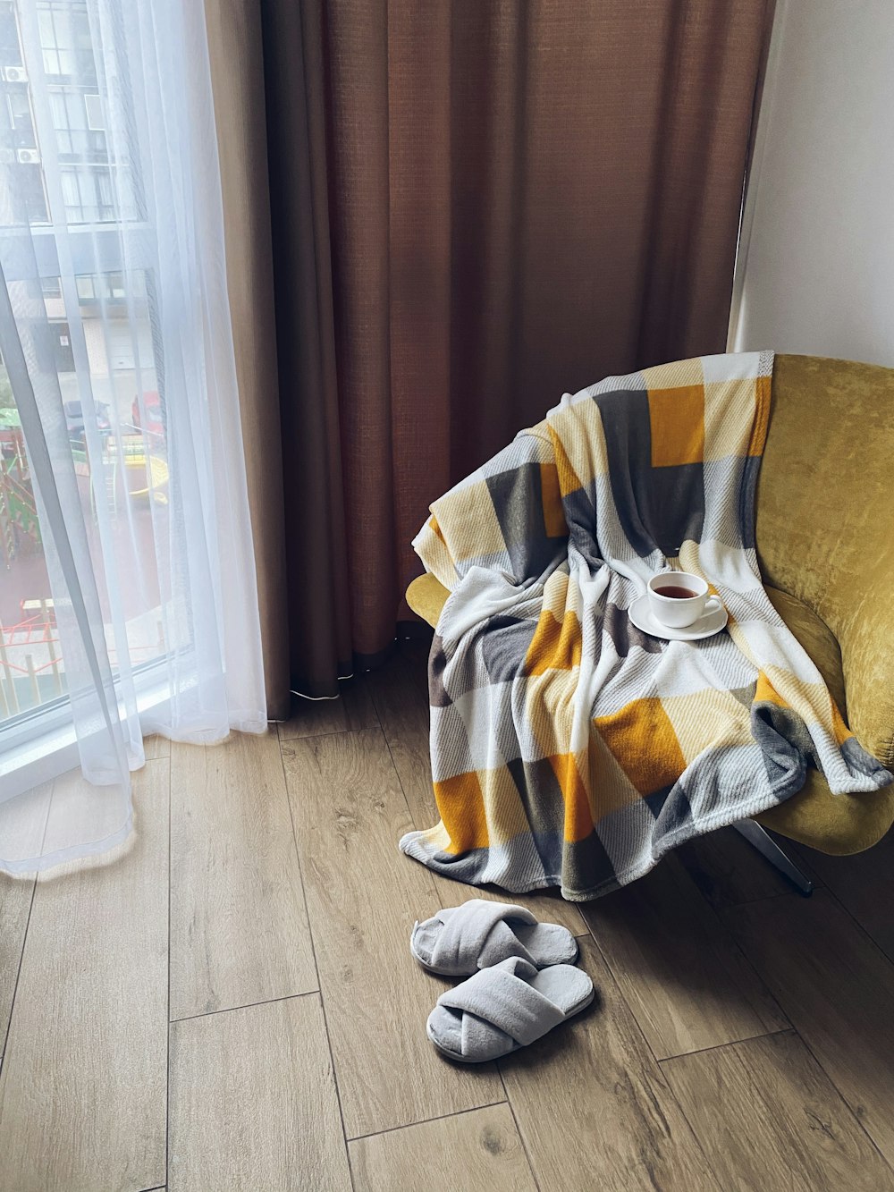 white and yellow textile on brown chair