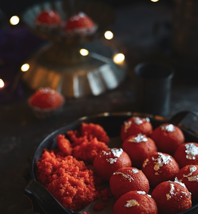 red strawberries on black ceramic bowl