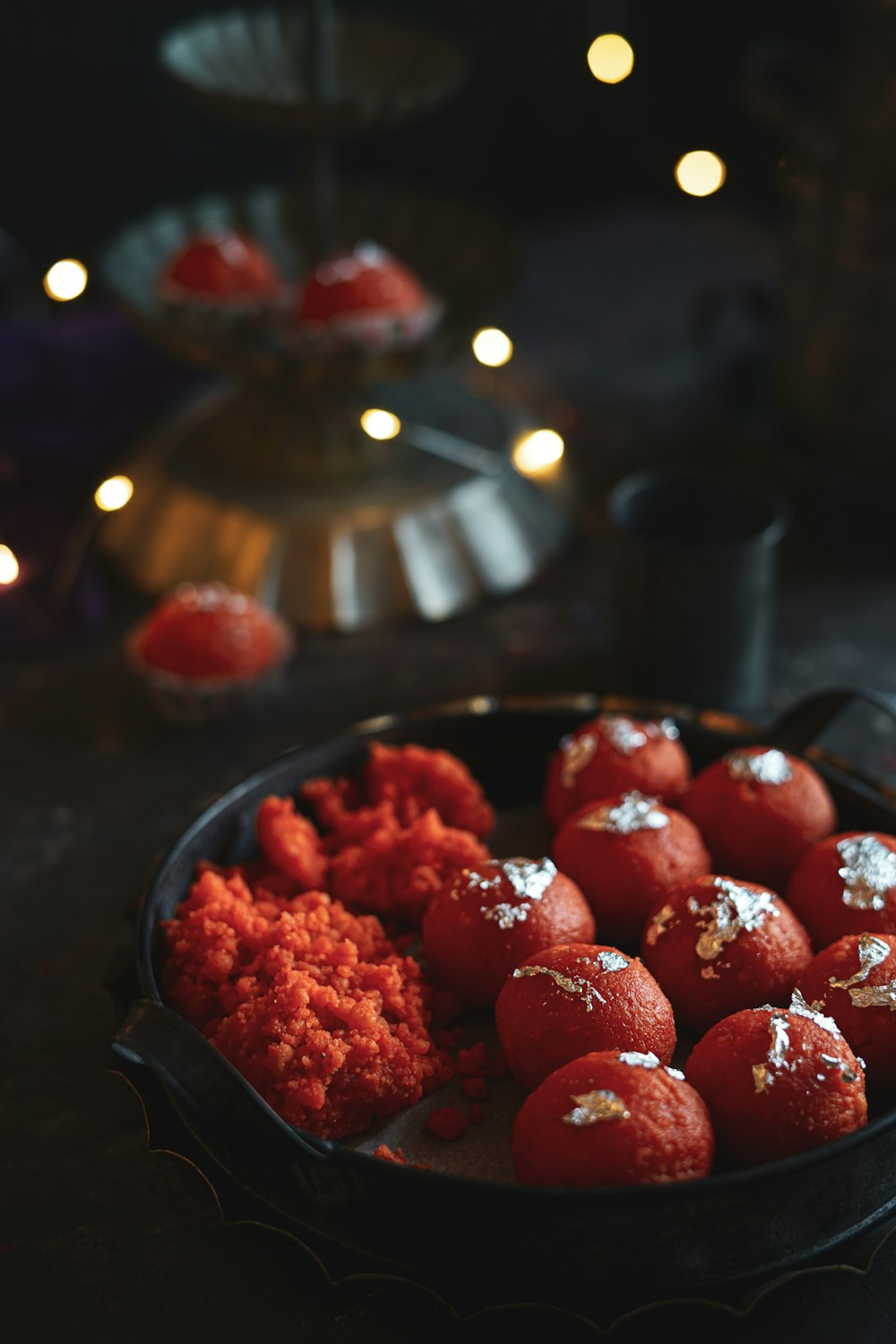 red strawberries on black ceramic bowl