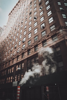 brown concrete building with smoke