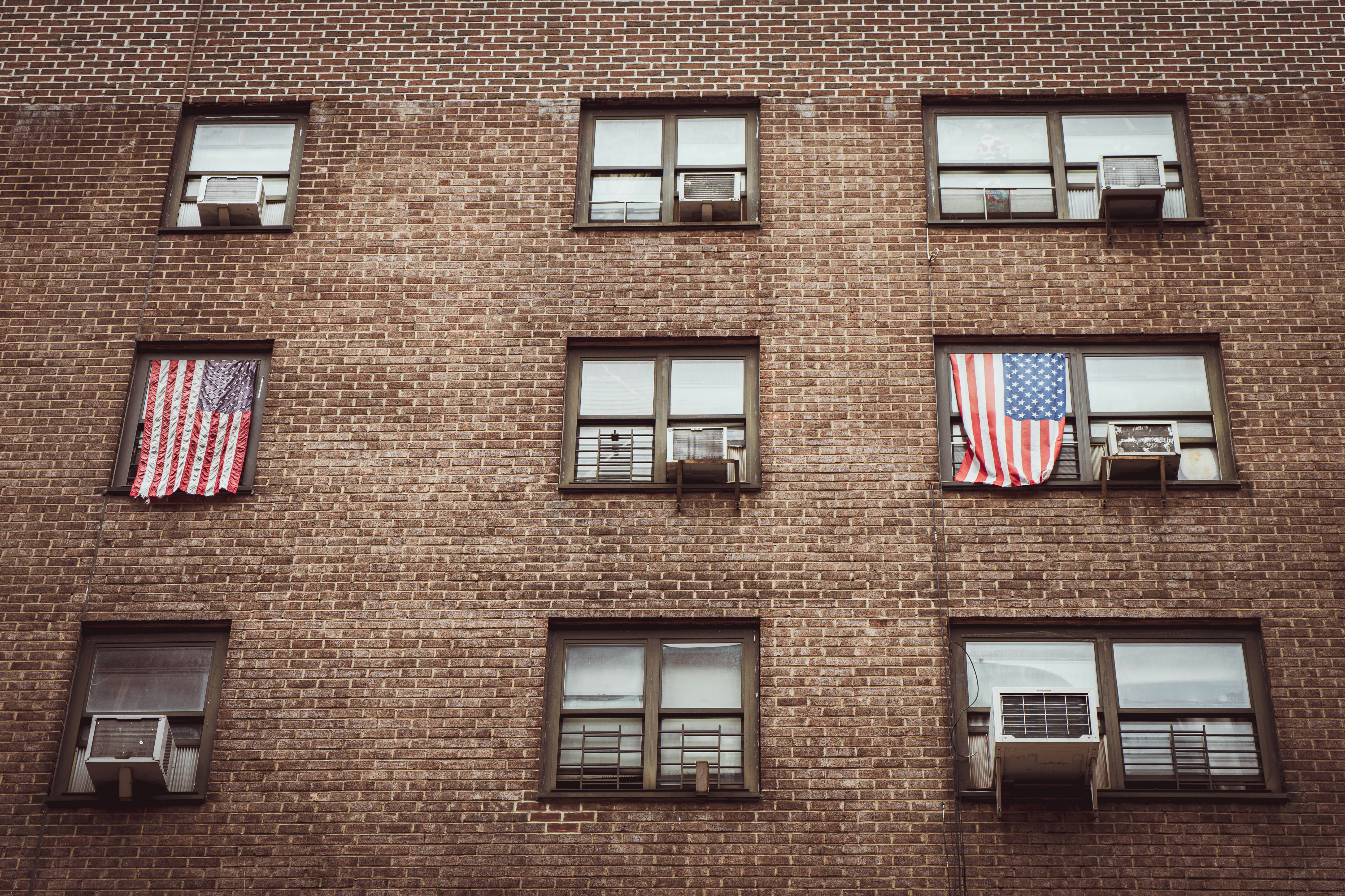 brown-brick-building-with-us-flag-on-top