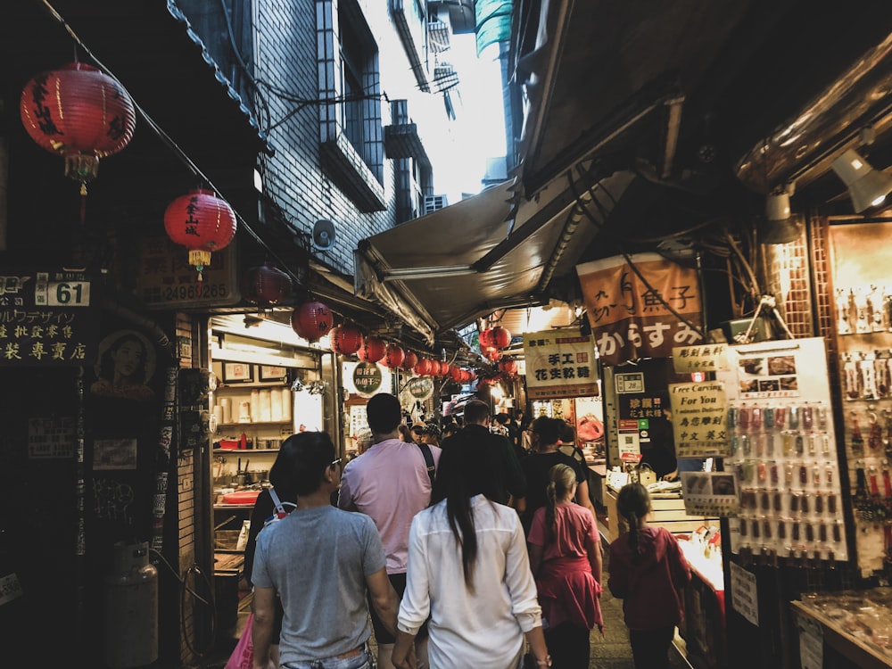 people walking on street during night time