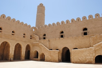 brown concrete building under blue sky during daytime