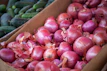 red onion on brown wooden crate