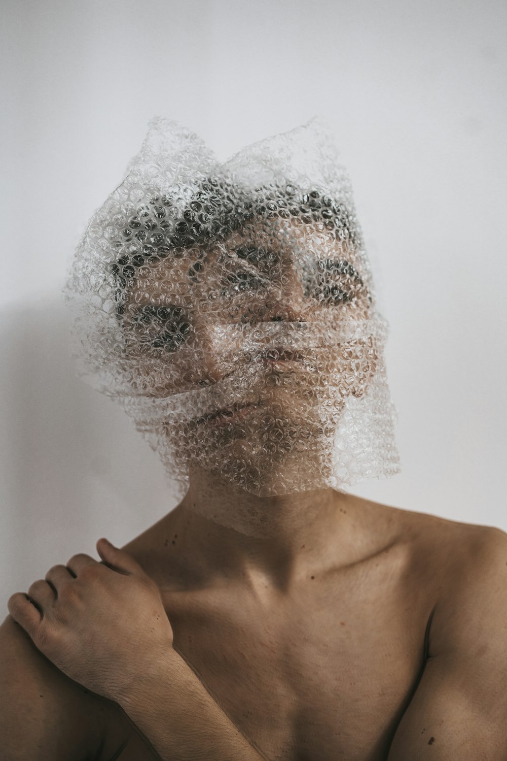 topless man with white powder on face