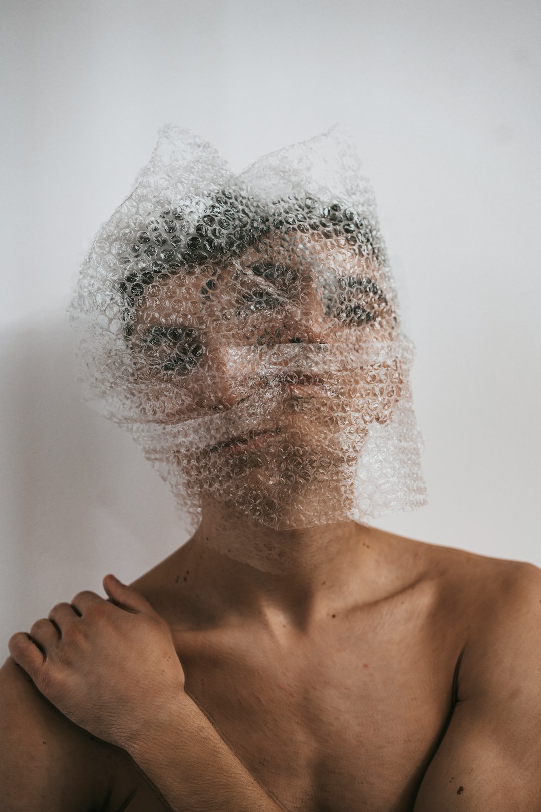 topless man with white powder on face