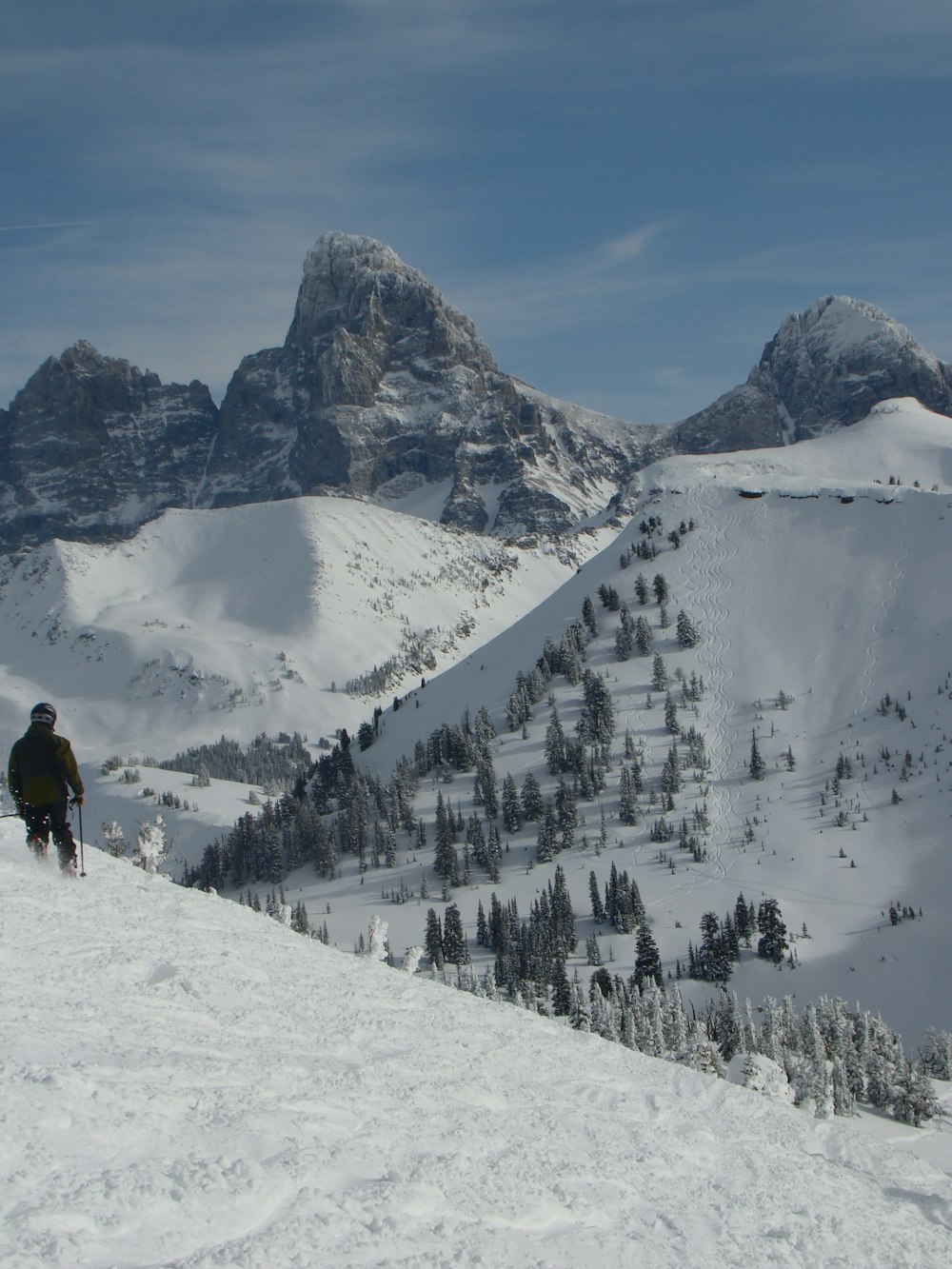 man in black jacket and black pants standing on snow covered ground during daytime