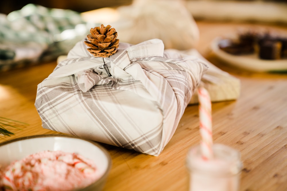 brown and white plaid textile on brown wooden table