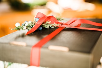 Close-up of a beautifully wrapped corporate gift with a ribbon.
