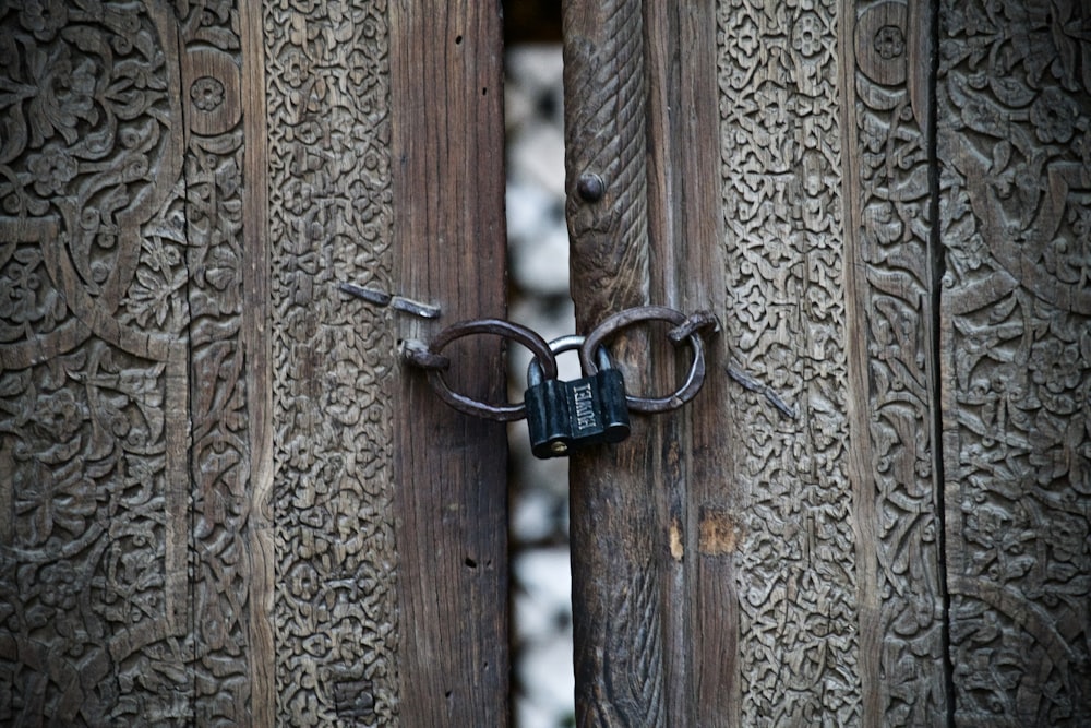 blue padlock on brown wooden fence