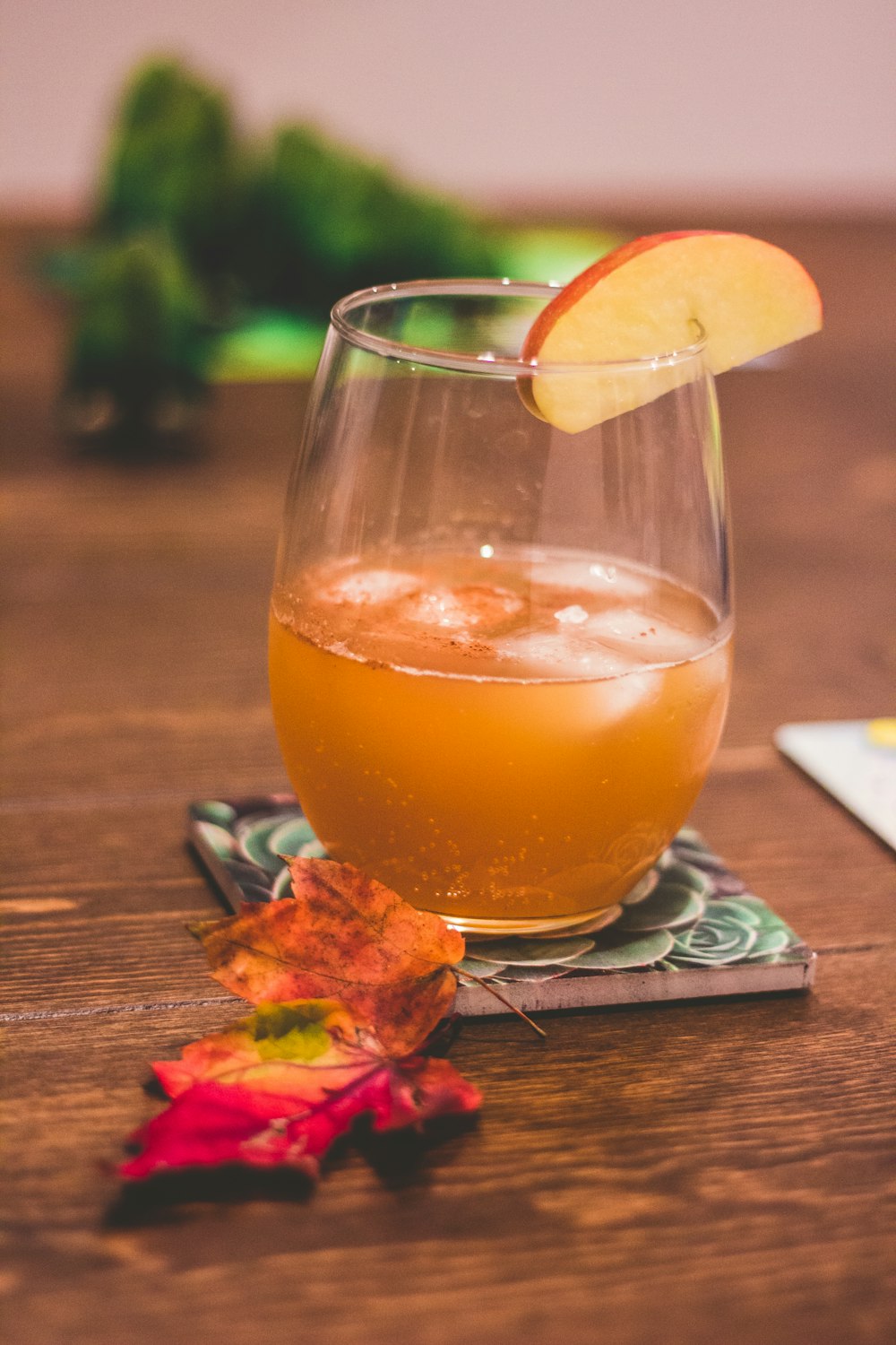 clear drinking glass with brown liquid and lemon