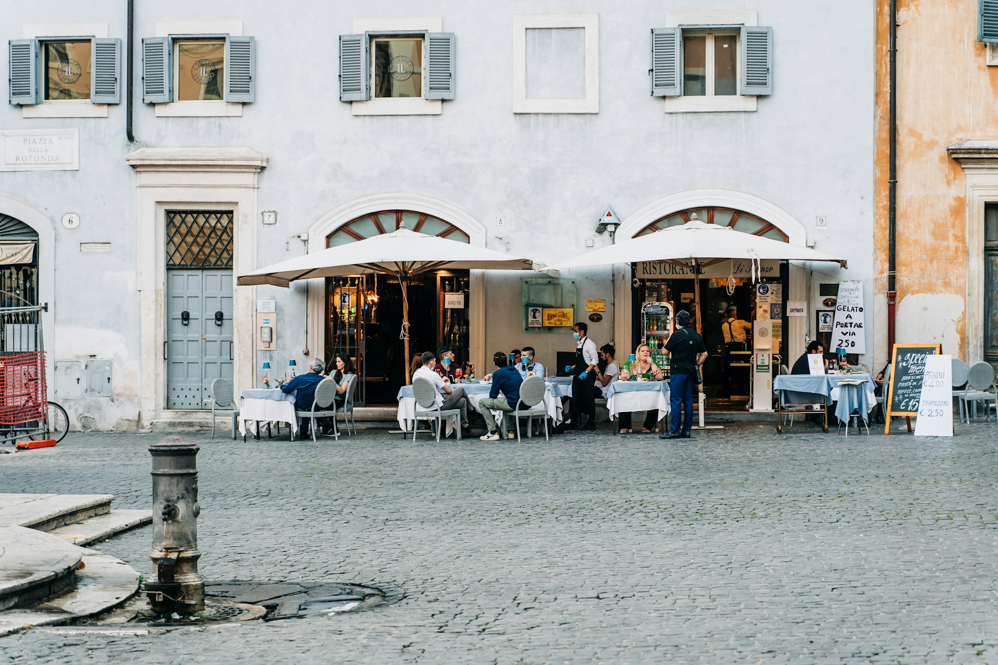 Tourists and locals enjoying a meal at a typical restaurant in Rome, Italy during the Covid-19 pandemic