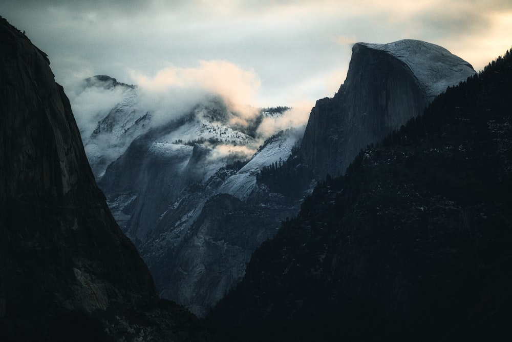 black and white mountains under white clouds