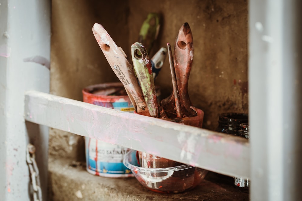 red and silver scissors on white plastic container