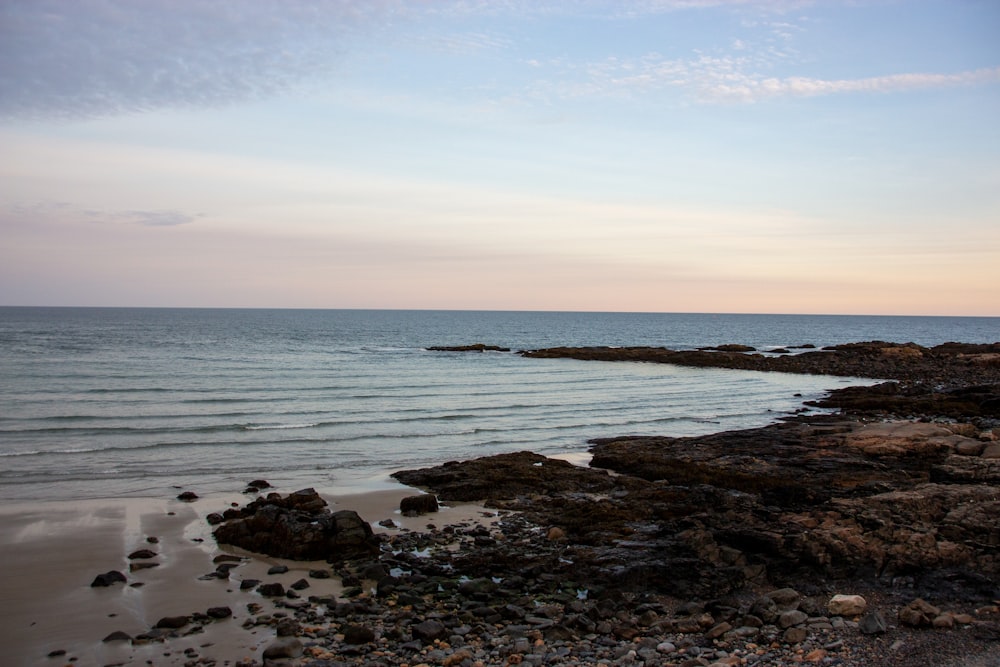 brown rocks on sea shore during daytime