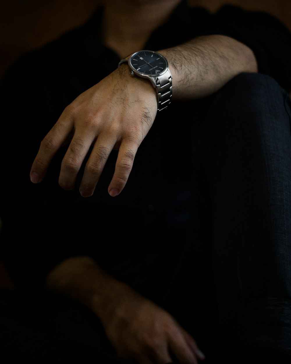 person wearing silver round analog watch