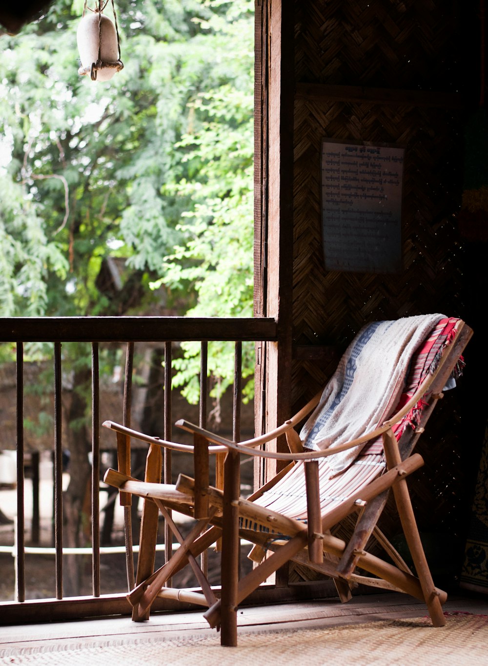 brown wooden armchair with blue and white textile