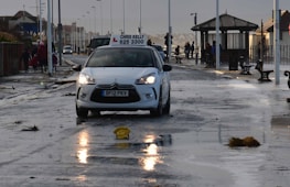 Students practicing driving lessons with an instructor in a car.