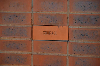 brown brick wall with no smoking sign