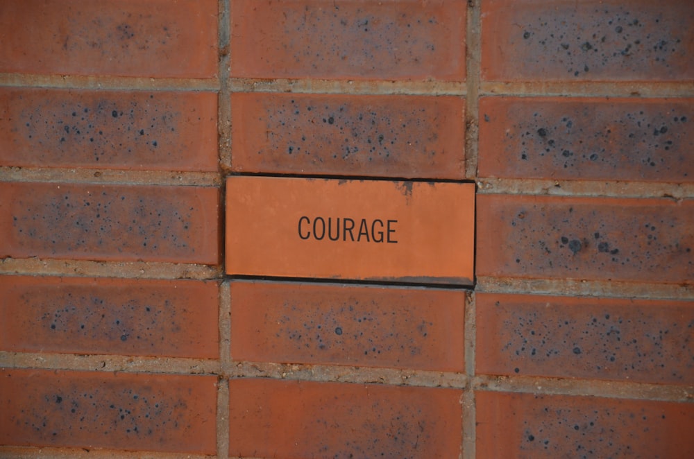 brown brick wall with no smoking sign