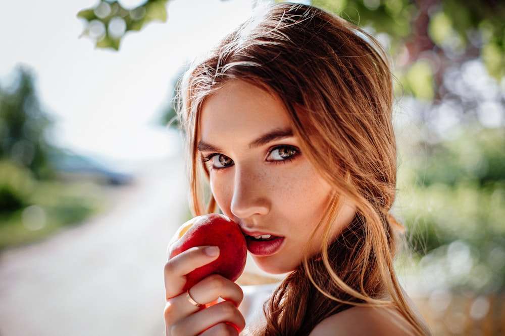 woman holding red apple fruit