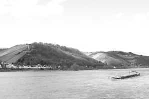 A serene river flowing through a village benefiting from water conservation efforts