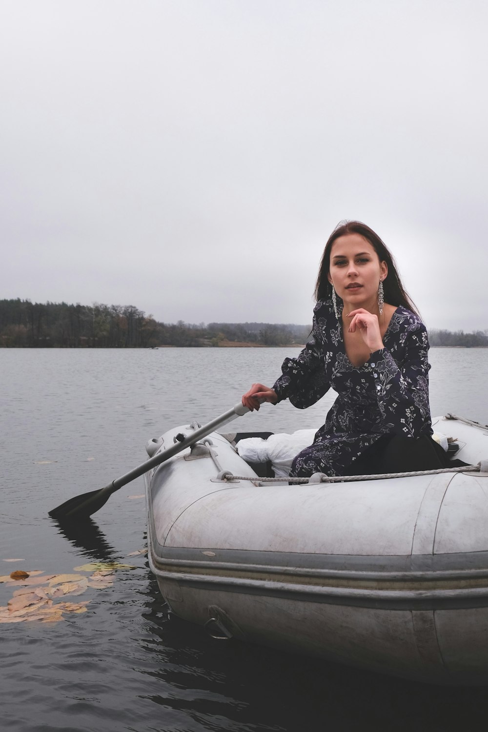 woman in black and white long sleeve shirt riding on white boat during daytime