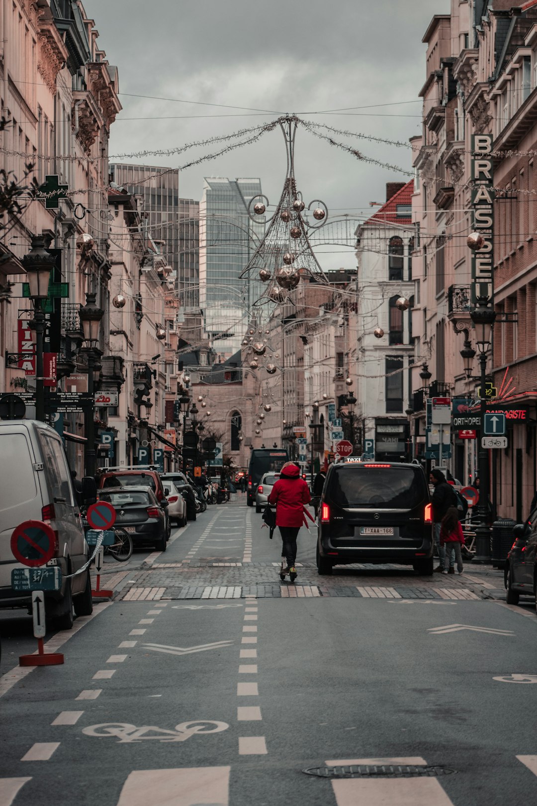 cars on road between buildings during daytime