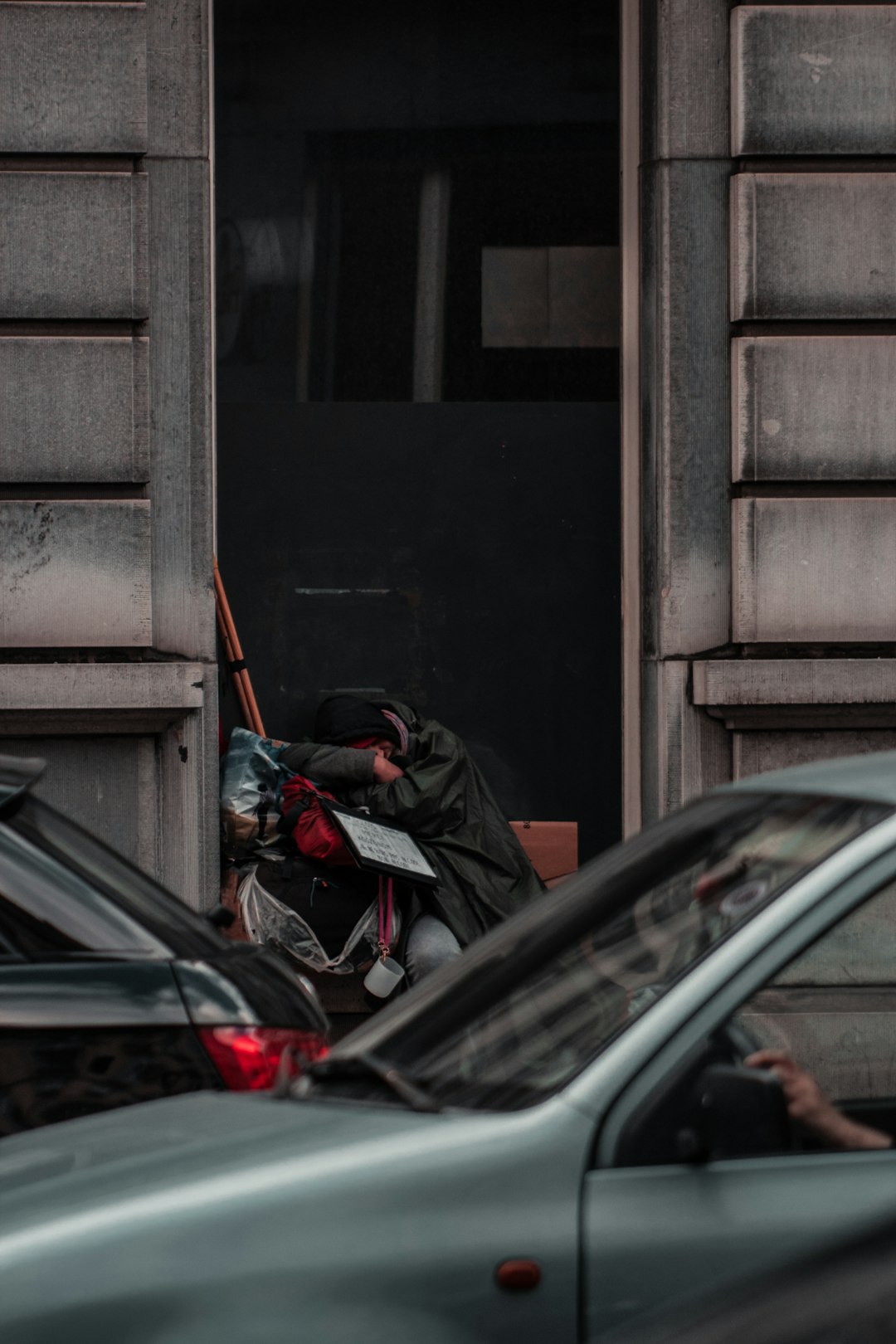 black car parked beside brown wooden door