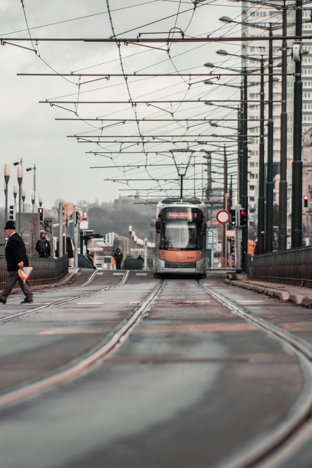 people walking on sidewalk near train during daytime