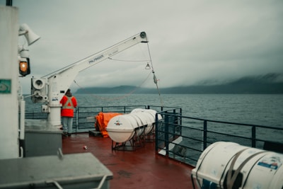 a man standing on the deck of a boat