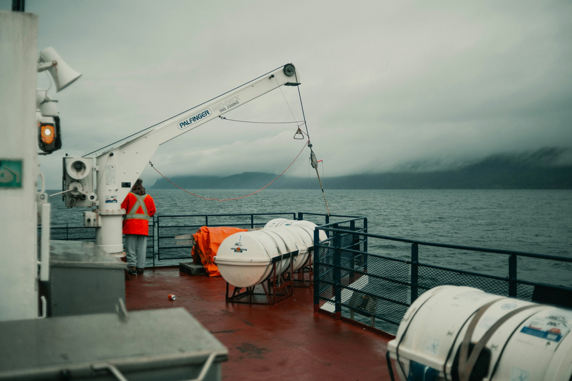 a man standing on the deck of a boat
