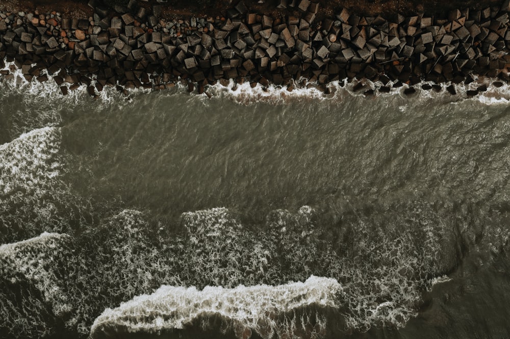 water waves hitting rocks during daytime