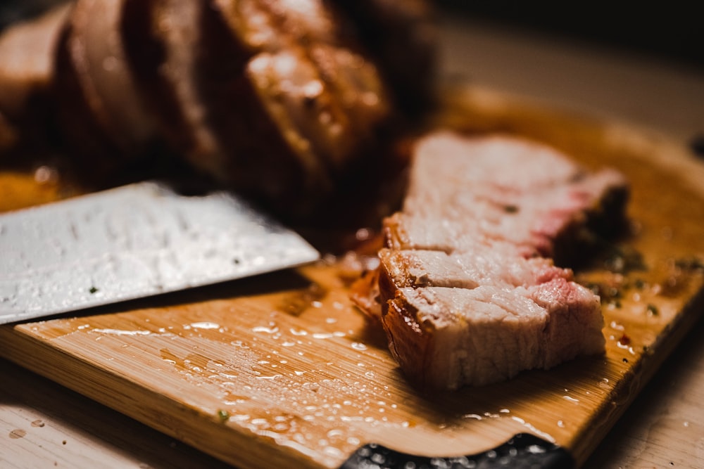 sliced meat on brown wooden chopping board